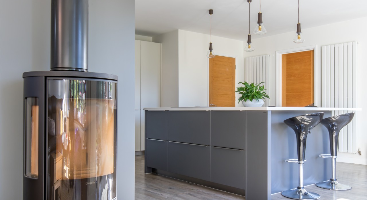 Wood burner in two-tone kitchen