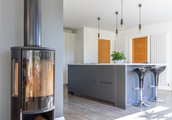 Wood burner in two-tone kitchen